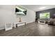 Modern living room with sleek floors, contemporary furniture, and a large wall-mounted TV at 4076 Sonoma Wood Trl, Decatur, GA 30034
