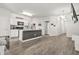 Open-concept living space with a kitchen, modern lighting, and sleek, continuous flooring at 4076 Sonoma Wood Trl, Decatur, GA 30034