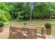 Staged back deck featuring a wooden dining table with seating and wooded views at 803 Cedar Lake Se Dr, Conyers, GA 30094