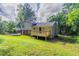 Exterior of home with new deck, grass, and wooded views at 803 Cedar Lake Se Dr, Conyers, GA 30094
