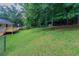 Large grassy and fenced backyard with new deck and wooded backdrop at 803 Cedar Lake Se Dr, Conyers, GA 30094