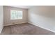 Cozy bedroom with neutral walls, carpet flooring, and natural light from the window at 803 Cedar Lake Se Dr, Conyers, GA 30094