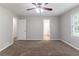 Spacious bedroom with neutral paint, plush carpet, ceiling fan, and natural light at 803 Cedar Lake Se Dr, Conyers, GA 30094