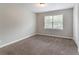 Bright bedroom with a large window, plush carpet, and neutral walls at 803 Cedar Lake Se Dr, Conyers, GA 30094