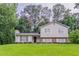 Charming two-story home with a well-manicured lawn and lush surrounding trees at 803 Cedar Lake Se Dr, Conyers, GA 30094