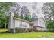 Side view of a two-story house featuring a brick foundation and vinyl siding at 803 Cedar Lake Se Dr, Conyers, GA 30094