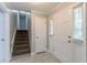 Inviting foyer featuring a staircase and a bright, naturally lit entrance at 803 Cedar Lake Se Dr, Conyers, GA 30094