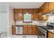 Bright kitchen featuring stainless steel appliances, wooden cabinets, and tile backsplash at 803 Cedar Lake Se Dr, Conyers, GA 30094