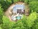 Aerial view showcasing the backyard with a pool, deck, and mature landscaping, creating a private oasis at 95 Weslyan Way, Oxford, GA 30054