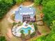 Expansive aerial view of a private estate featuring a pool, patio, and lush landscaping at 95 Weslyan Way, Oxford, GA 30054