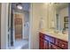 Well-lit bathroom with wood vanity, granite countertop, and shower stall in the background at 95 Weslyan Way, Oxford, GA 30054