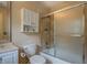 Bathroom featuring a shower-tub combination with sliding glass doors and storage cabinet at 95 Weslyan Way, Oxford, GA 30054