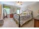 Airy bedroom with a decorative metal bed frame, ceiling fan and lots of natural light at 95 Weslyan Way, Oxford, GA 30054