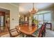 Spacious dining room featuring a chandelier, hardwood floors, and a large window with natural light at 95 Weslyan Way, Oxford, GA 30054