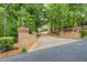 Long driveway leading to a home surrounded by trees at 95 Weslyan Way, Oxford, GA 30054