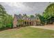 Elegant brick home with a manicured front lawn and inviting covered front porch at 95 Weslyan Way, Oxford, GA 30054