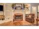 Cozy fireplace with decorative mantel, built-in shelves, and hardwood floors at 95 Weslyan Way, Oxford, GA 30054