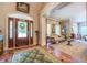 Inviting foyer featuring a decorative front door, elegant marble floors, and a glimpse into the living area at 95 Weslyan Way, Oxford, GA 30054