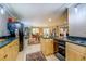 Spacious kitchen with stainless steel appliances, granite countertops, light wood cabinets, and tile flooring at 95 Weslyan Way, Oxford, GA 30054