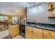 Large kitchen area with stainless steel sink, granite countertops, and an open view to the dining area at 95 Weslyan Way, Oxford, GA 30054
