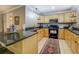 Well-lit kitchen featuring stainless steel appliances, granite countertops, and light wood cabinetry at 95 Weslyan Way, Oxford, GA 30054