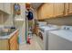 Functional laundry room with built-in cabinets, granite countertop, sink, and modern appliances at 95 Weslyan Way, Oxford, GA 30054