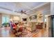 Elegant living room boasts coffered ceilings, a ceiling fan, and hardwood floors at 95 Weslyan Way, Oxford, GA 30054