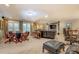 The living room features multiple leather seating areas, custom cabinetry, and abundant natural light at 95 Weslyan Way, Oxford, GA 30054