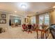 Living room has an additional game table area and multiple windows for abundant natural light at 95 Weslyan Way, Oxford, GA 30054