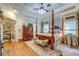 Spacious main bedroom with four-poster bed, sitting area, and fireplace, offering a luxurious retreat at 95 Weslyan Way, Oxford, GA 30054