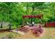 Wooden pergola featuring outdoor seating surrounded by greenery and stairs at 95 Weslyan Way, Oxford, GA 30054