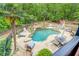 Resort-style pool area with lush landscaping, a rock waterfall feature, and plenty of seating at 95 Weslyan Way, Oxford, GA 30054