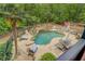 A resort-like pool with waterfalls, lush landscaping, and various seating at 95 Weslyan Way, Oxford, GA 30054