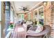 Cozy screened-in porch with comfortable seating and brick accents, perfect for enjoying the outdoors at 95 Weslyan Way, Oxford, GA 30054