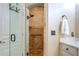 Modern walk-in shower with stone tile, providing a luxurious and accessible bathing experience at 95 Weslyan Way, Oxford, GA 30054
