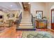 Grand staircase with wrought iron railing, leading to the upper level, enhancing the home's elegance and charm at 95 Weslyan Way, Oxford, GA 30054