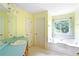 Bright bathroom with a garden tub, window, green countertop, and vanity at 21 Wisteria Run, Hiram, GA 30141