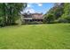 Exterior of the home with a covered patio and large grassy backyard at 1777 E Gate Trl, Stone Mountain, GA 30087