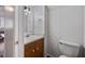 Bathroom featuring a single sink vanity with wood cabinets and a standard toilet at 1777 E Gate Trl, Stone Mountain, GA 30087