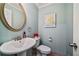 A charming powder room is decorated with an ornate mirror, flowers and an 'Eat Well, Travel Often' sign at 1777 E Gate Trl, Stone Mountain, GA 30087