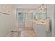 Bright bathroom featuring a double vanity, large mirror, and neutral tile flooring at 1777 E Gate Trl, Stone Mountain, GA 30087