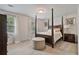 Bedroom with four-poster bed, neutral carpet, and ample natural light at 1777 E Gate Trl, Stone Mountain, GA 30087