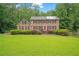 Traditional brick home with a manicured lawn and mature trees at 1777 E Gate Trl, Stone Mountain, GA 30087