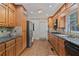 A well-lit kitchen features granite countertops, wooden cabinets, tile backsplash and stainless steel appliances at 1777 E Gate Trl, Stone Mountain, GA 30087