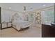 An elegant main bedroom featuring decorative mirrors, a ceiling fan and neutral walls at 1777 E Gate Trl, Stone Mountain, GA 30087