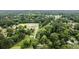 An aerial view shows a home in a neighborhood with lush greenery and mature trees at 3978 Oglesby Rd, Powder Springs, GA 30127