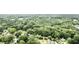 A home surrounded by many mature trees in a quiet neighborhood seen in an aerial view at 3978 Oglesby Rd, Powder Springs, GA 30127