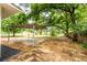 The backyard has a partial structure on a concrete slab and a view of the wooded surroundings at 3978 Oglesby Rd, Powder Springs, GA 30127