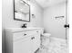 Bathroom featuring a modern vanity, a large mirror, and a toilet at 3978 Oglesby Rd, Powder Springs, GA 30127
