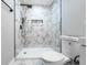Modern bathroom featuring a shower with marbled tile, black hardware, and a built-in niche at 3978 Oglesby Rd, Powder Springs, GA 30127